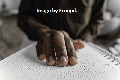 An image of an man reading braille.